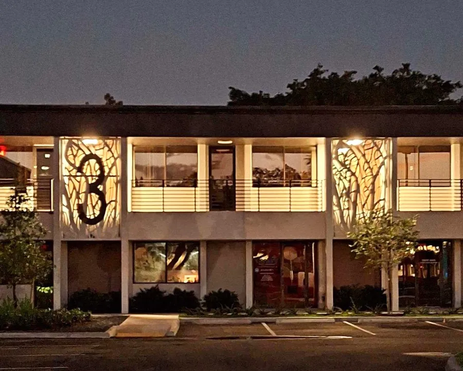 Building 3 at dusk with backlit decorative screens
